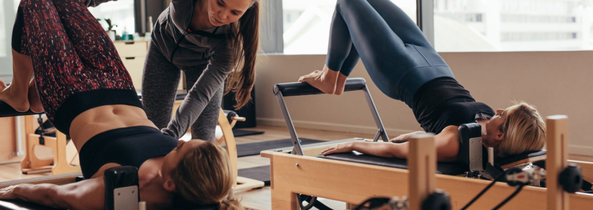 Pilates,Instructor,Training,Women,At,The,Gym.,Two,Fitness,Women